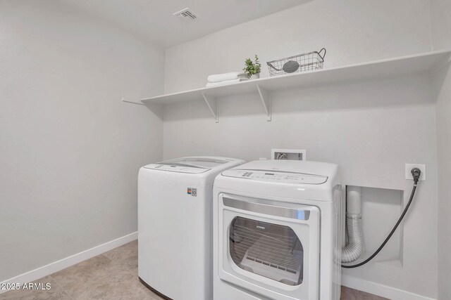 242 N Crosscreek Dr, Chandler, AZ 85225 - laundry room with washing machine and dryer, baseboards, and light tile patterned flooring