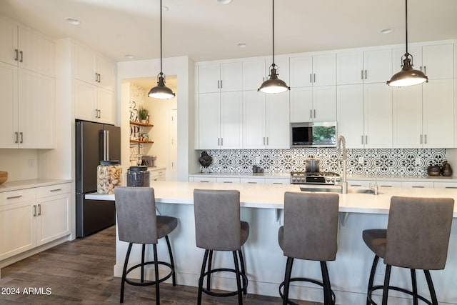 kitchen featuring a center island with sink and decorative light fixtures