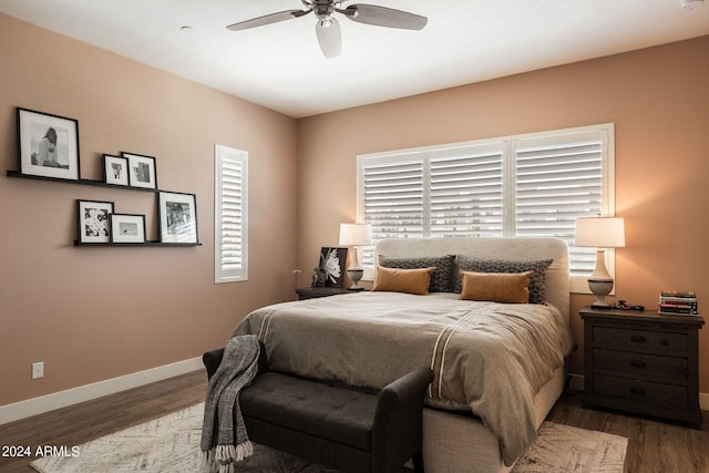 bedroom with ceiling fan and dark hardwood / wood-style floors