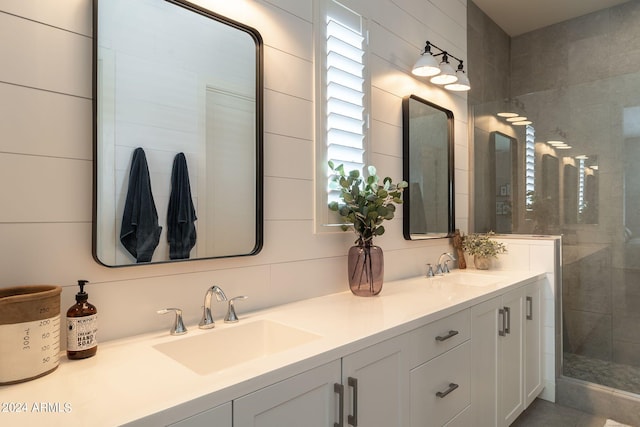 bathroom with vanity and a shower with door