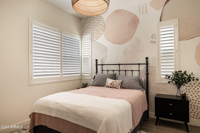 bedroom with dark hardwood / wood-style floors