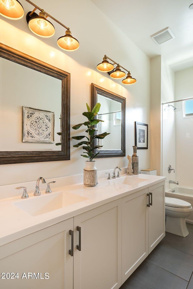 full bathroom featuring vanity, bathtub / shower combination, and toilet