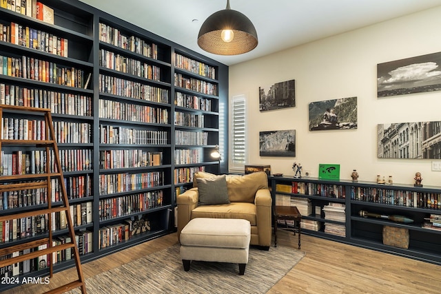 sitting room with wood-type flooring