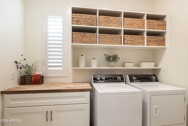 laundry area with cabinets and washer and clothes dryer