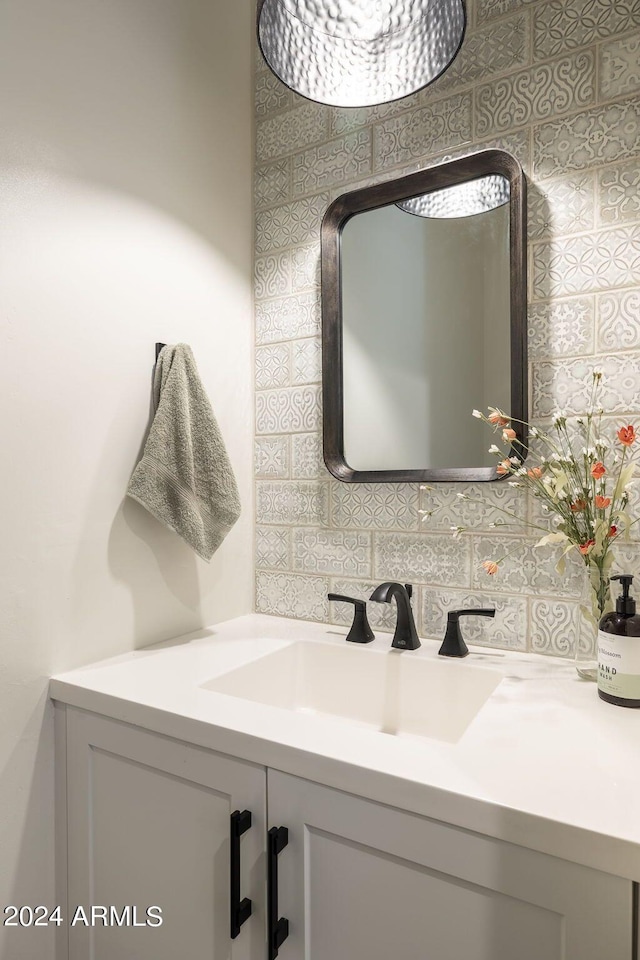 bathroom with vanity and tasteful backsplash