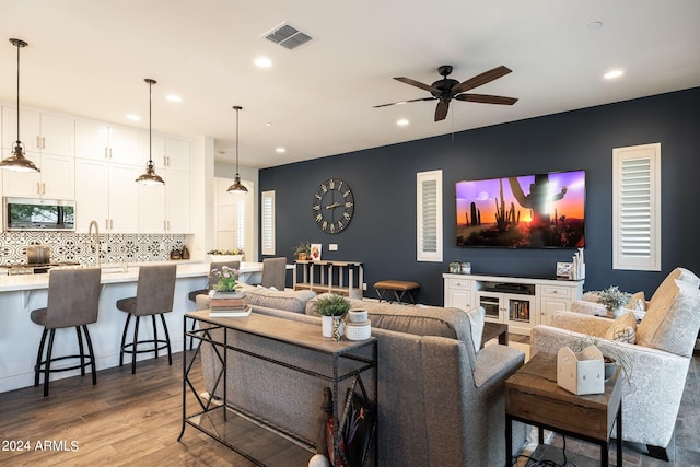 living room featuring ceiling fan and light wood-type flooring