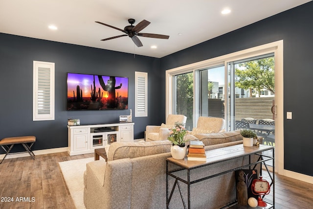 living room with ceiling fan and light hardwood / wood-style flooring