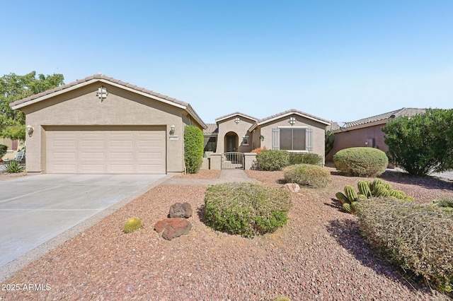 mediterranean / spanish-style home with a tile roof, stucco siding, a gate, a garage, and driveway