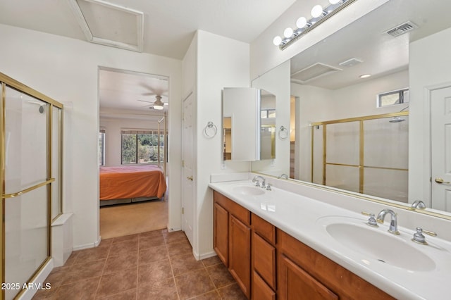 bathroom with a shower stall, visible vents, and a sink