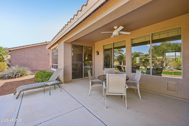 view of patio with a ceiling fan and outdoor dining space