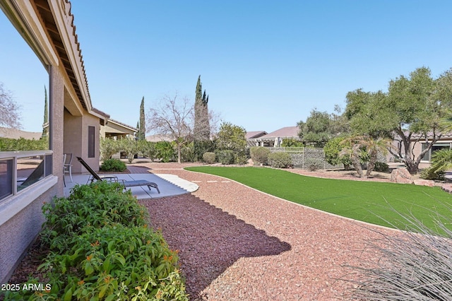 view of yard with fence and a patio