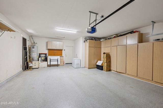 garage featuring gas water heater and a garage door opener