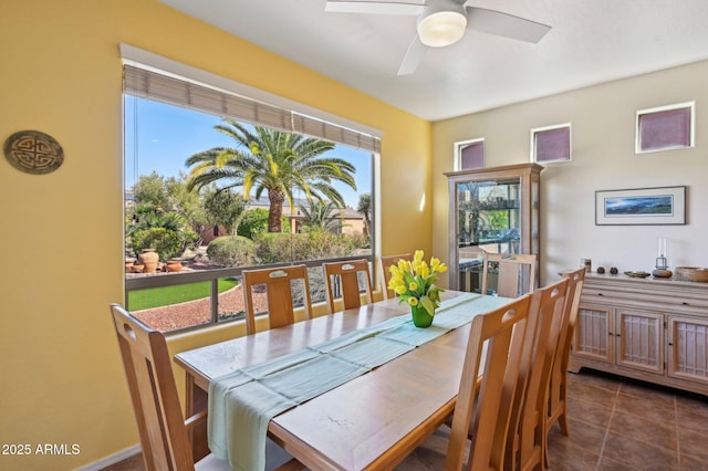 tiled dining room featuring ceiling fan