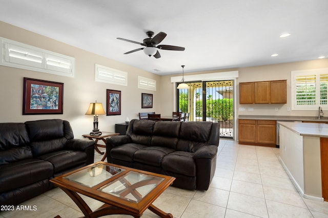 living room with sink, ceiling fan, and light tile patterned floors