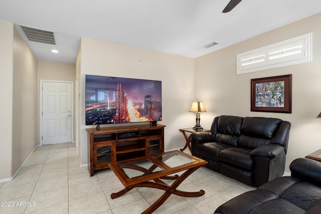 tiled living room with ceiling fan