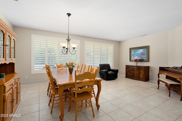 dining space with an inviting chandelier and light tile patterned floors