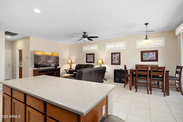 kitchen featuring ceiling fan, light tile patterned flooring, and decorative light fixtures