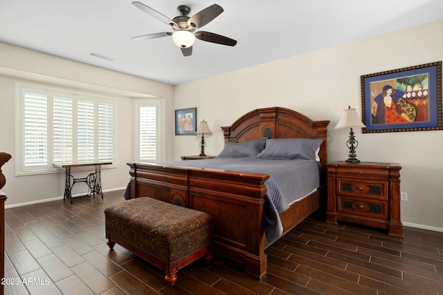 bedroom with ceiling fan, multiple windows, and dark hardwood / wood-style floors