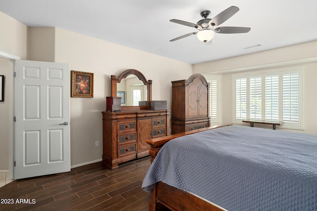 bedroom with ceiling fan and dark hardwood / wood-style flooring