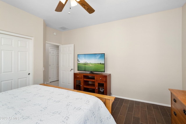 bedroom with a closet, ceiling fan, and dark hardwood / wood-style floors