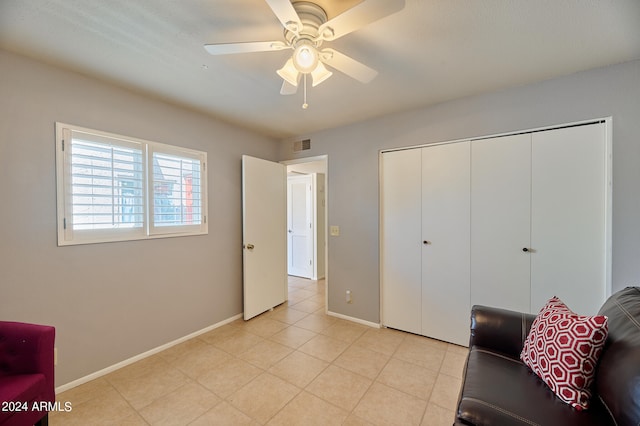 interior space featuring light tile patterned floors and ceiling fan