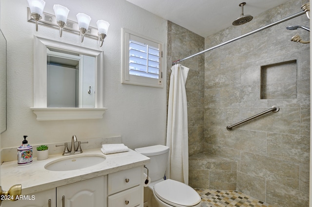 bathroom with a shower with curtain, vanity, and toilet