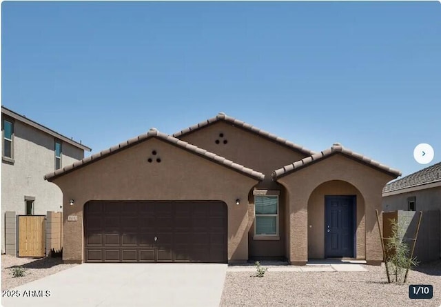 mediterranean / spanish-style home with a garage