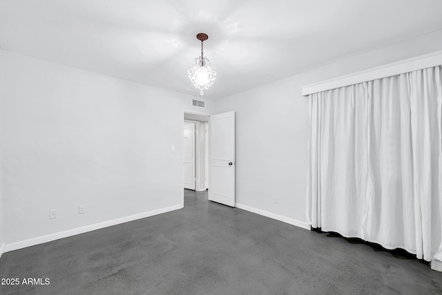 empty room with a notable chandelier