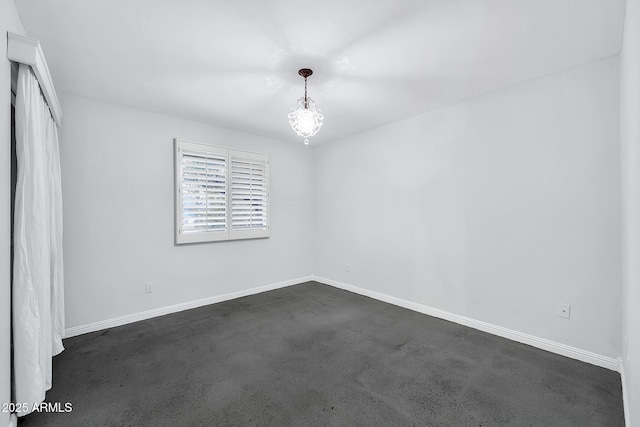 spare room featuring an inviting chandelier