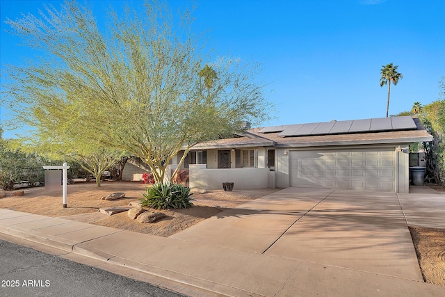 view of front of home with a garage and solar panels