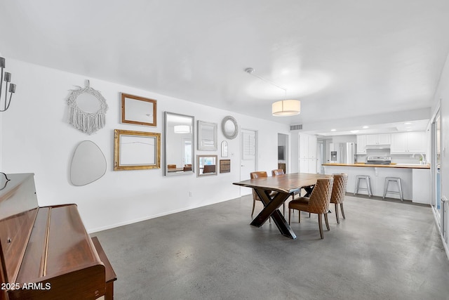 dining space featuring concrete flooring