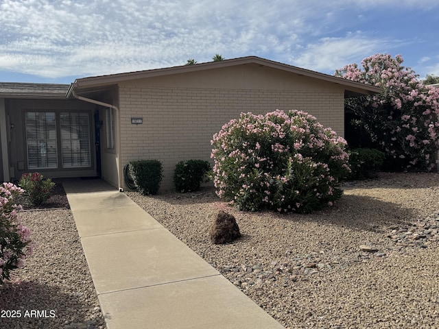 entrance to property featuring brick siding