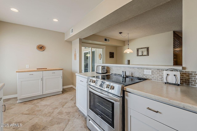 kitchen with visible vents, pendant lighting, stainless steel electric range, white cabinets, and backsplash