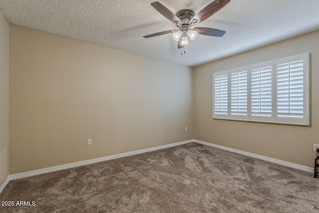 empty room featuring baseboards, carpet flooring, a textured ceiling, and ceiling fan