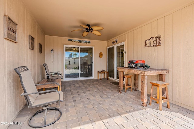 view of patio featuring outdoor dry bar and a ceiling fan