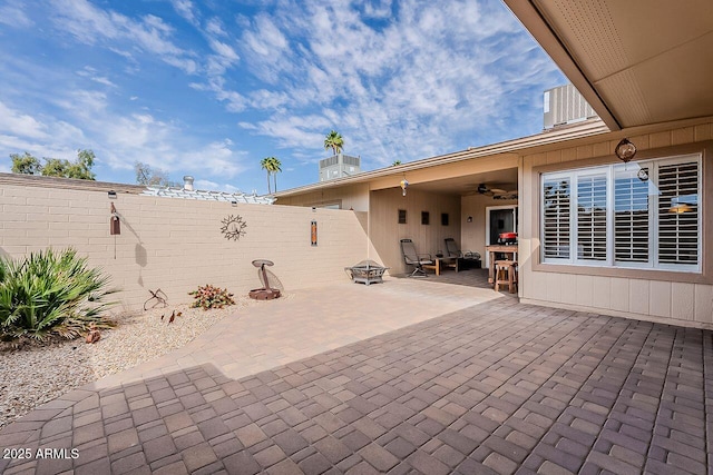 view of patio / terrace with central AC, a ceiling fan, and fence