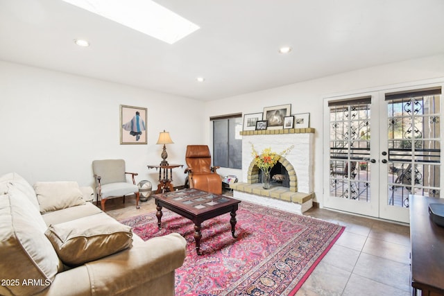 living room with a skylight, tile patterned floors, and french doors