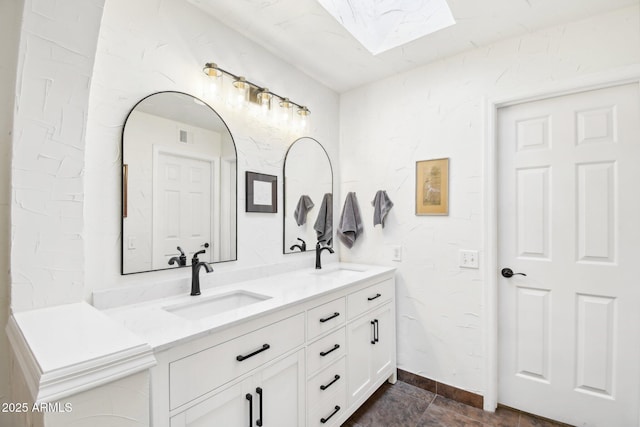 bathroom featuring vanity and a skylight