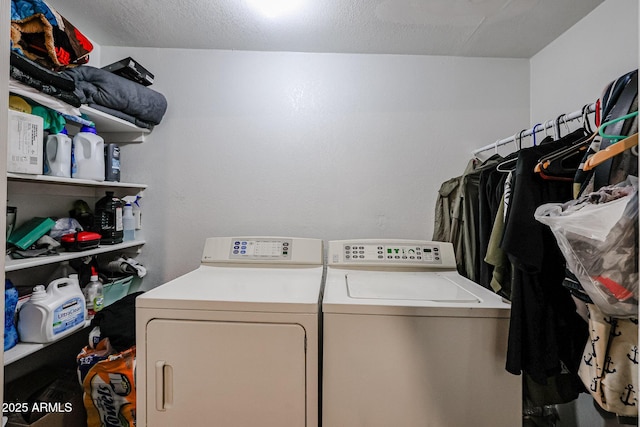 washroom featuring washer and dryer and a textured ceiling