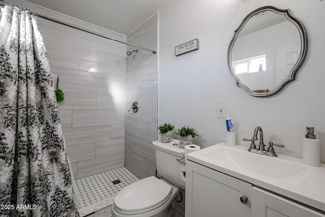 bathroom featuring vanity, curtained shower, and toilet