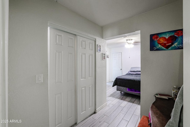 bedroom with light wood-type flooring and a closet