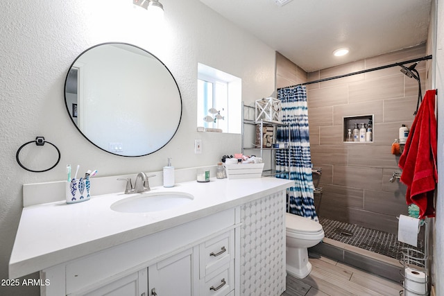 bathroom with vanity, a shower with shower curtain, and toilet