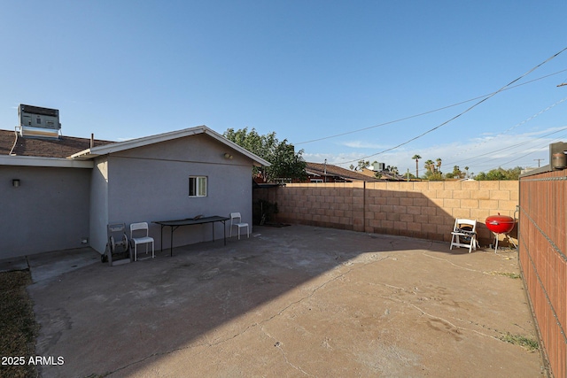 rear view of property featuring central air condition unit and a patio