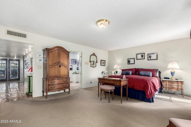 carpeted bedroom featuring a textured ceiling