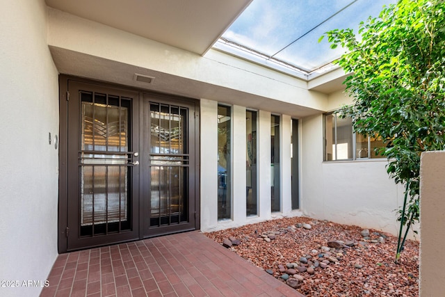 view of exterior entry featuring french doors