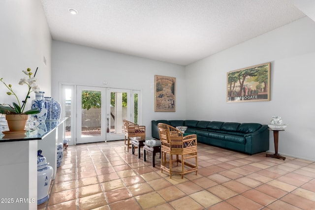 tiled living room featuring french doors and a textured ceiling