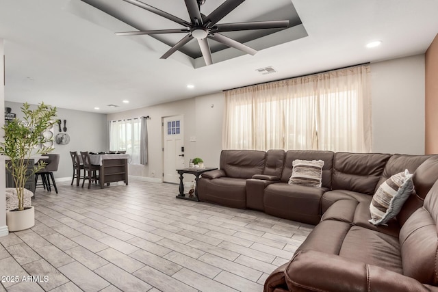 living room featuring recessed lighting, a ceiling fan, and baseboards