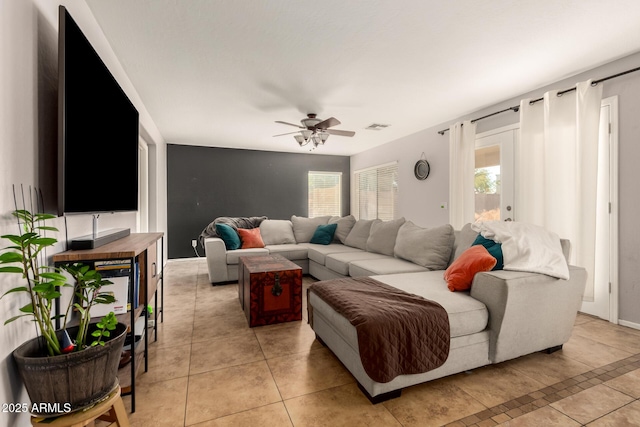 living room featuring light tile patterned floors and ceiling fan