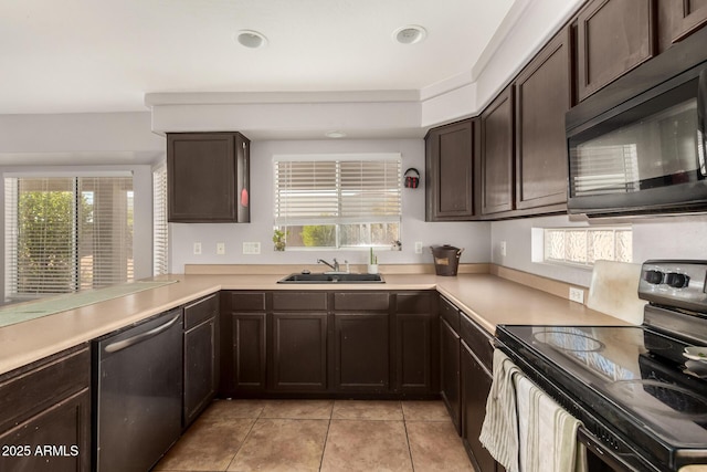 kitchen featuring dishwasher, black electric range oven, sink, kitchen peninsula, and a healthy amount of sunlight