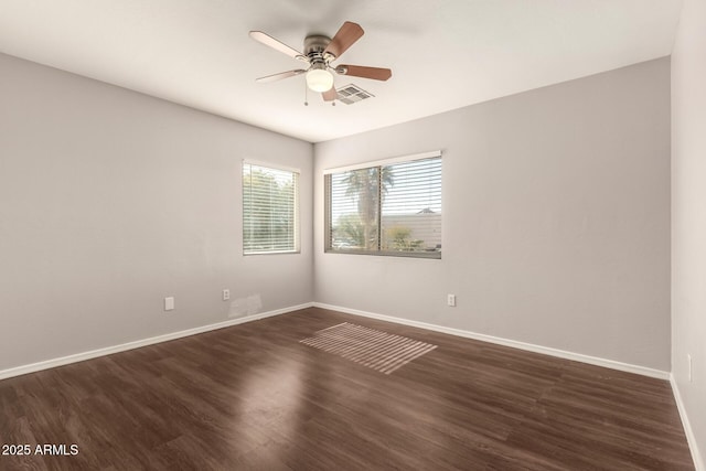 unfurnished room with dark hardwood / wood-style floors and ceiling fan